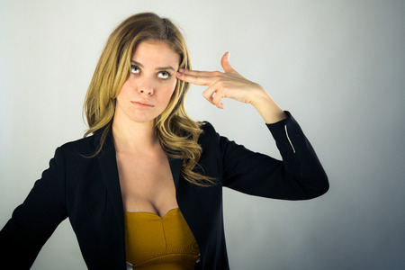 attractive woman on plein background shot in studio with soft lights with an interesting expression and dramatic lightingの写真素材