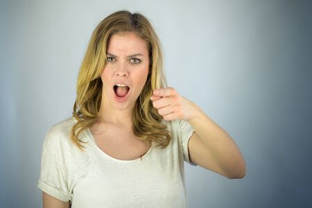 attractive woman on plein background shot in studio with soft lights with an interesting expression and dramatic lightingの写真素材