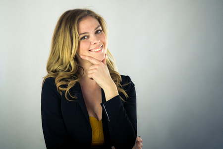 attractive woman on plein background shot in studio with soft lights with an interesting expression and dramatic lightingの写真素材
