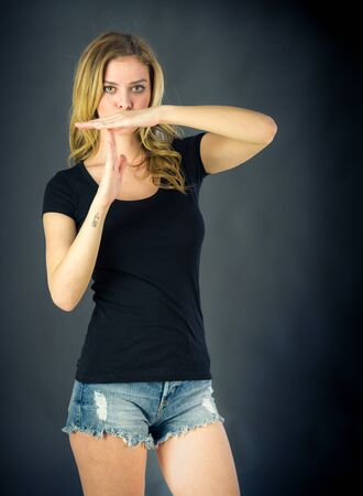 attractive woman on plein background shot in studio with soft lights with an interesting expression and dramatic lightingの写真素材