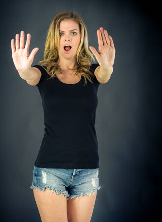 attractive woman on plein background shot in studio with soft lights with an interesting expression and dramatic lightingの写真素材