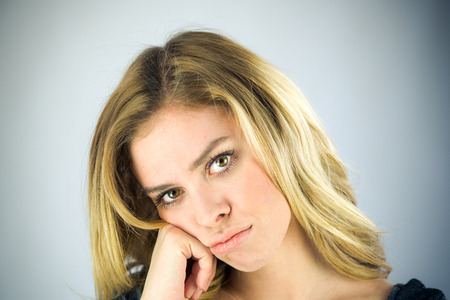 attractive woman on plein background shot in studio with soft lights with an interesting expression and dramatic lightingの写真素材