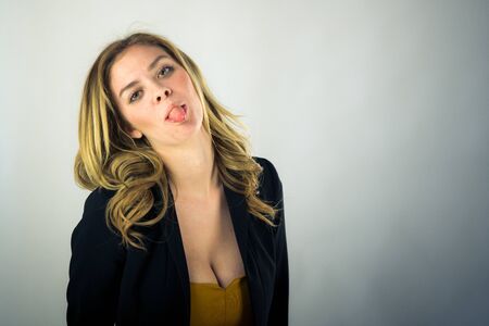 attractive woman on plein background shot in studio with soft lights with an interesting expression and dramatic lightingの写真素材