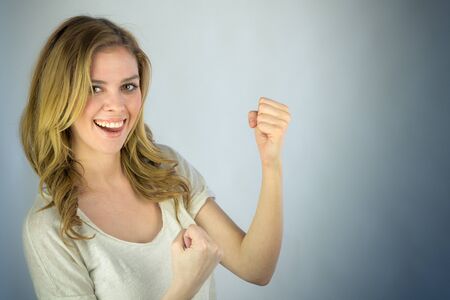 attractive woman on plein background shot in studio with soft lights with an interesting expression and dramatic lightingの写真素材