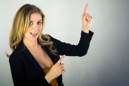 attractive woman on plein background shot in studio with soft lights with an interesting expression and dramatic lightingの写真素材