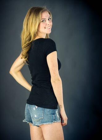 attractive woman on plein background shot in studio with soft lights with an interesting expression and dramatic lightingの写真素材