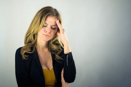 attractive woman on plein background shot in studio with soft lights with an interesting expression and dramatic lightingの写真素材