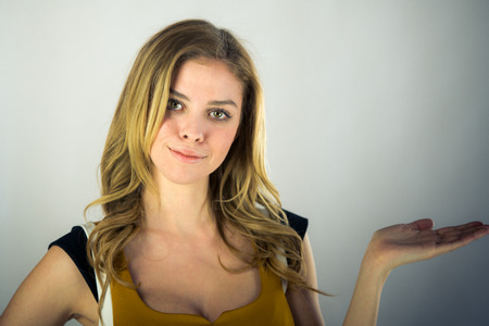 attractive woman on plein background shot in studio with soft lights with an interesting expression and dramatic lightingの写真素材