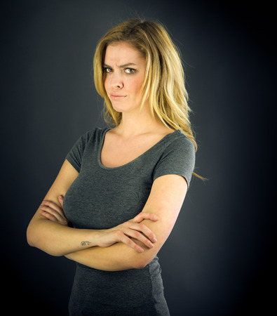 attractive woman on plein background shot in studio with soft lights with an interesting expression and dramatic lightingの写真素材