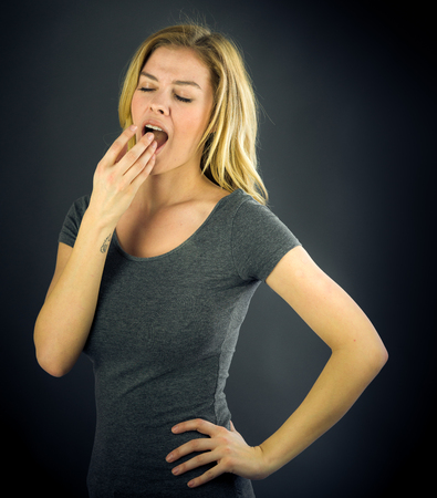 attractive woman on plein background shot in studio with soft lights with an interesting expression and dramatic lightingの写真素材
