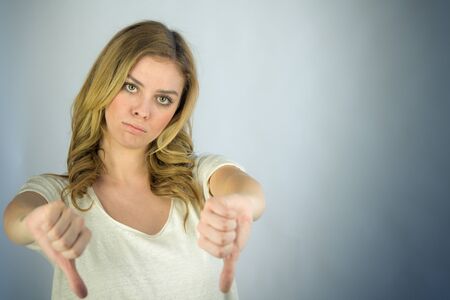 attractive woman on plein background shot in studio with soft lights with an interesting expression and dramatic lightingの写真素材