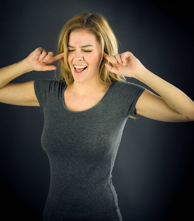 attractive woman on plein background shot in studio with soft lights with an interesting expression and dramatic lightingの写真素材