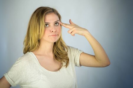 attractive woman on plein background shot in studio with soft lights with an interesting expression and dramatic lightingの写真素材