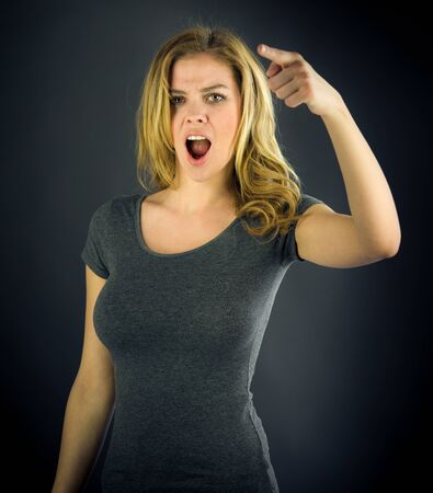 attractive woman on plein background shot in studio with soft lights with an interesting expression and dramatic lightingの写真素材