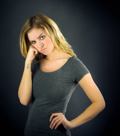 attractive woman on plein background shot in studio with soft lights with an interesting expression and dramatic lightingの写真素材