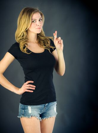 attractive woman on plein background shot in studio with soft lights with an interesting expression and dramatic lightingの写真素材