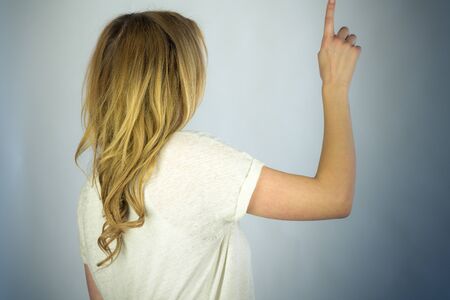 attractive woman on plein background shot in studio with soft lights with an interesting expression...