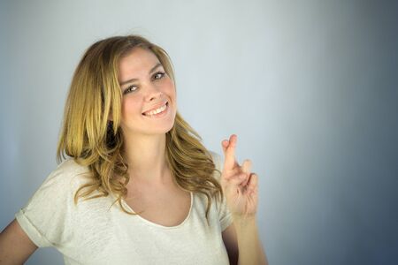 attractive woman on plein background shot in studio with soft lights with an interesting expression and dramatic lightingの写真素材