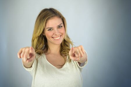 attractive woman on plein background shot in studio with soft lights with an interesting expression and dramatic lightingの写真素材