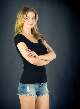 attractive woman on plein background shot in studio with soft lights with an interesting expression and dramatic lightingの写真素材