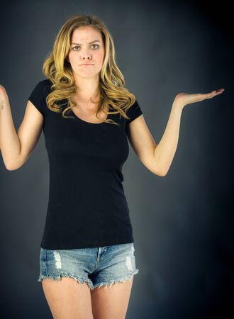attractive woman on plein background shot in studio with soft lights with an interesting expression and dramatic lightingの写真素材