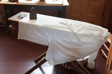 Absence, Wood - Material, Empty, Wrinkled, Laundry, Clothing, Appliance, Housework, Iron - Appliance, White, Preparation, Shirt, Morning, Ironing Board, Three Objects, Still Life, Domestic Life, Domestic Room, Chores, Colour Image, Home Interior, Photograの写真素材