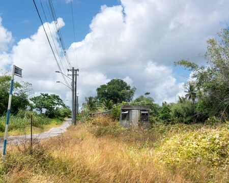 Building Exterior, Built Structure, Cloud - Sky, Colour Image, Country Road, Day, Electricity Pylon, Grass, Horizontal, Hut, No People, Old, Outdoors, Photography, Power Cable, Power Line, Road, Road Sign, Roadside, Rural Scene, Shed, Sky, Street Light, Tの写真素材