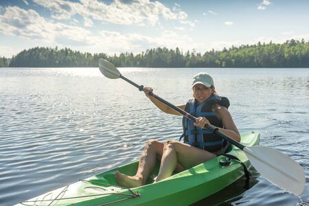woman sporty healthy kayaking on the lakeの写真素材