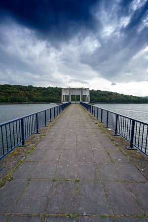 Empty pier and railings with diminishing perspective, clouds in sky, Belgium. belgium europeの写真素材