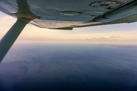 View from underneath an aircraft wing looking over the sea. aerial picture from ontario canada 2016の写真素材