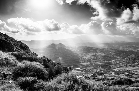 Scenic view of patchwork agricultural landscape and mountain against cloudy sky, Crete, Greeceの写真素材
