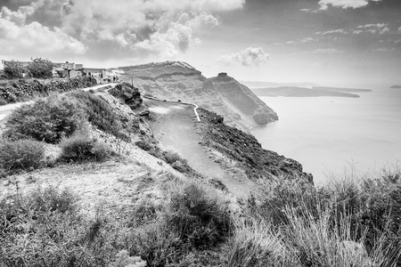 Dirt road along the coastline of Santorini islandの写真素材