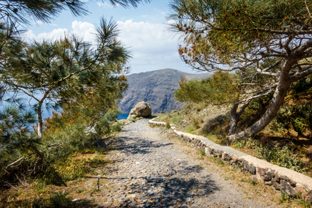 Dirt road leading towards Santorini islandの写真素材