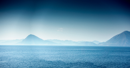 Panoramic view of seascape against mountain; Greeceの写真素材