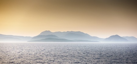 Scenic view of seascape against mountain during sunset; Greece