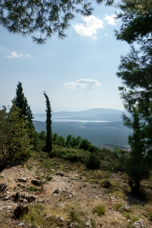Scenic mountain landscape and river against cloudy sky; Delphi; Greeceの写真素材