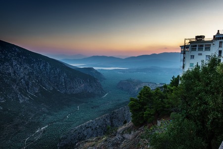 Scenic mountain landscape and bay of water against sky; Delphi; Greeceの写真素材