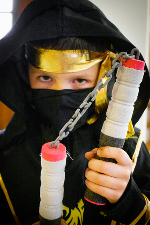 Boy in Ninja costume with Nunchaku Crete Greece Europeの写真素材