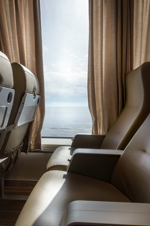 Airplane seat and window with curtains