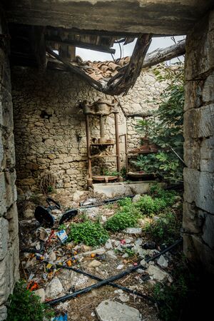 View of garbage and old ruined wallsの写真素材