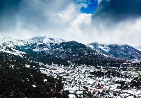 Snowcapped mountain landscape and agricultural field, Crete, Greeceの写真素材