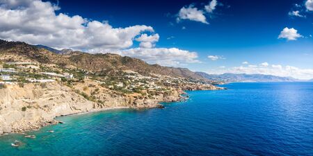 Scenic view of sea and mountain against cloudy sky, Crete, Greeceの写真素材