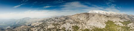 Panoramic view of mountains against sky with snowcapped mountain in backgroundの写真素材