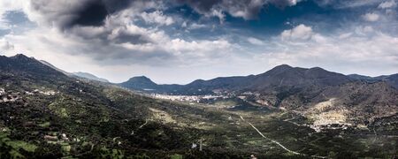 Majestic landscape with mountains against sky with cloudsの写真素材