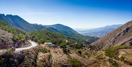 Scenic view of winding road and mountain against sky, Crete, Greeceの写真素材