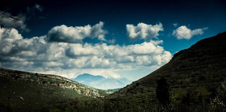 View of hilly landscape against skyの写真素材