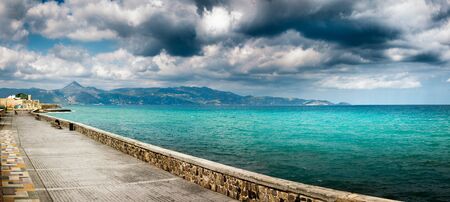 Seascape and mountain against cloudy sky, Heraklion, Crete, Greeceの写真素材