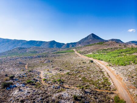 View of footpath amidst mountain landscape, Crete, Greeceの写真素材