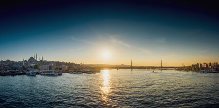 View of ship at harbor with bridge in the background during sunset, Istanbulの写真素材