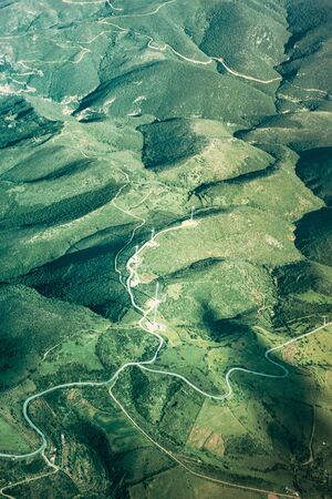 Aerial view of windmill turbine on agricultural field and mountain, Crete, Greeceの写真素材